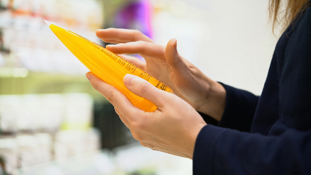 Person checking a short ingredient list on a product.